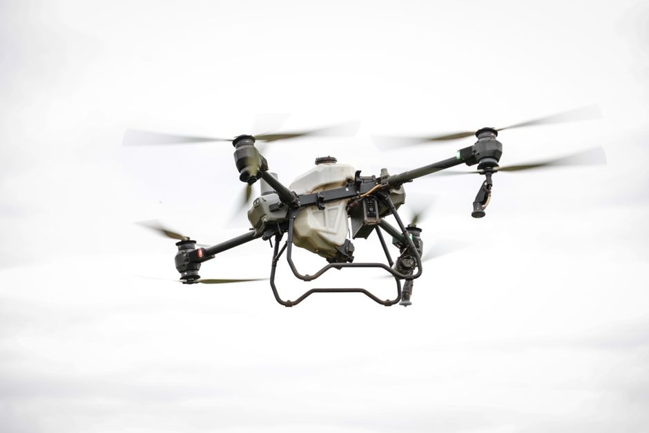 A drone flying over a rugged landscape, capturing geological survey data for analysis.